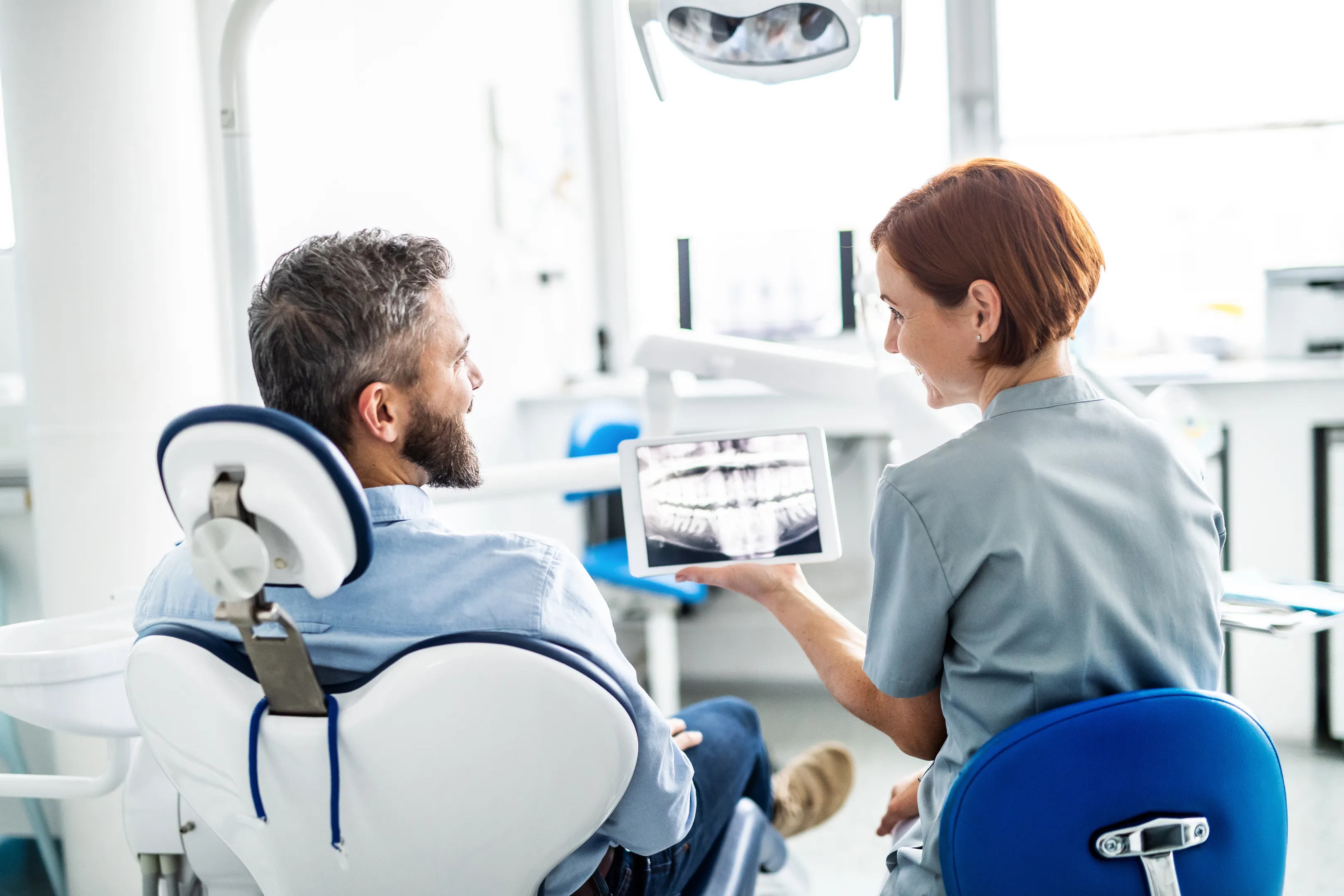 Dentist reviewing digital dental X-rays with a patient