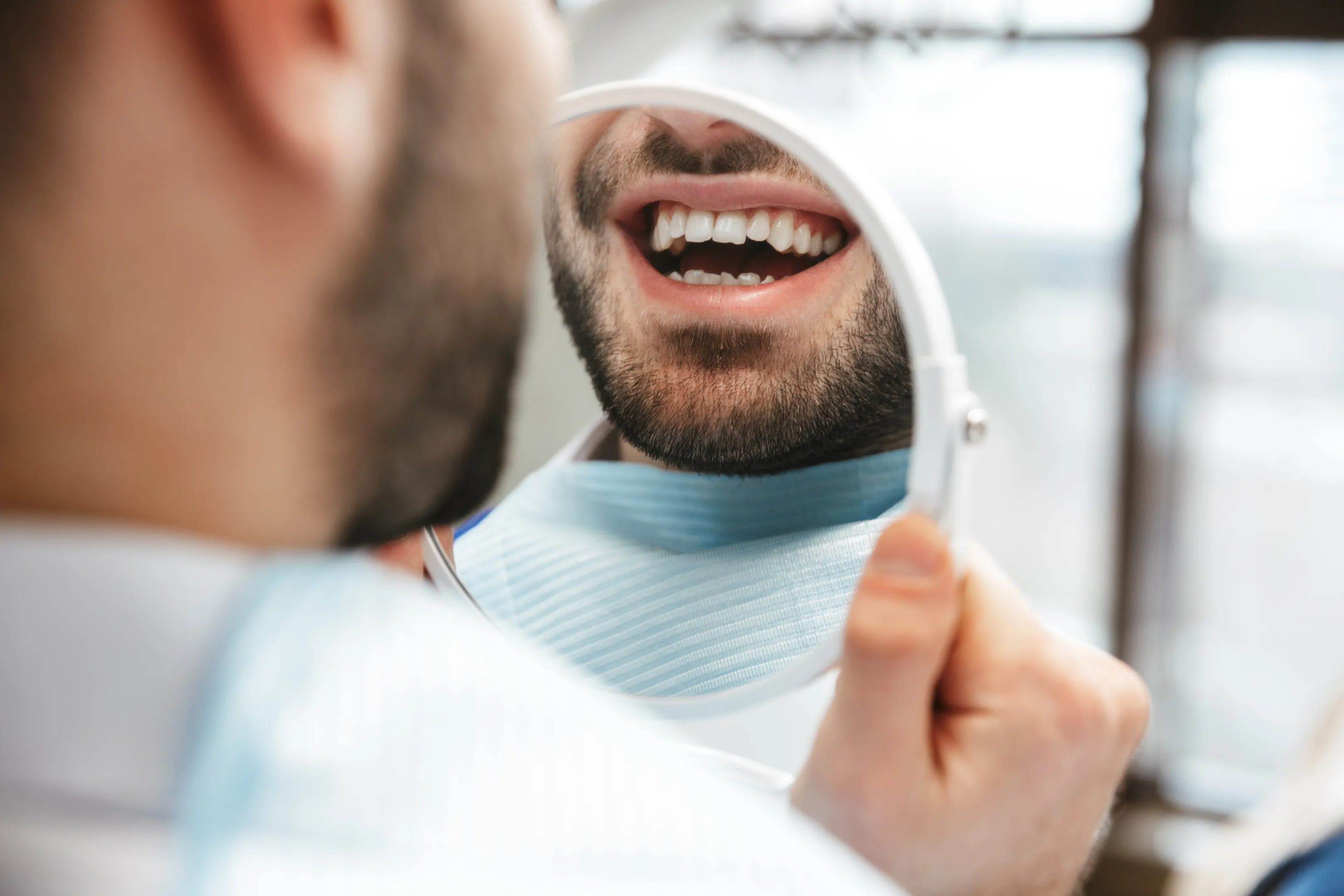 Happy Glassell Dental patient admiring their smile