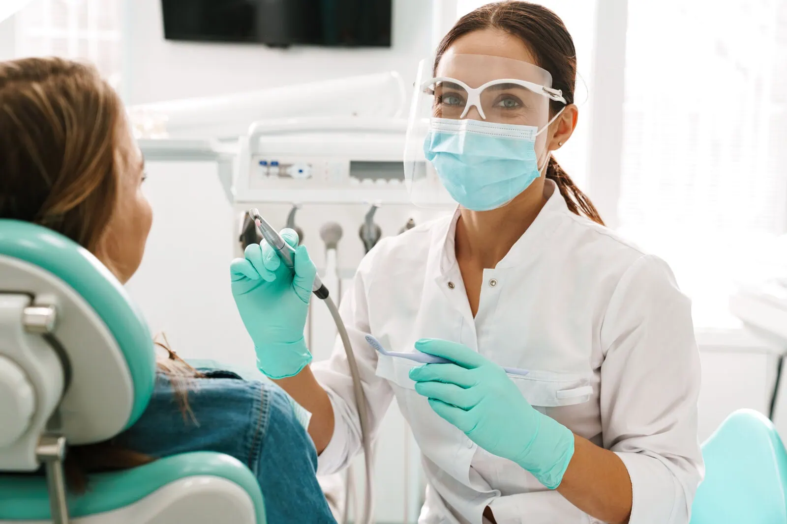 Dentist providing attentive, expert care to a patient at Glassell Dental