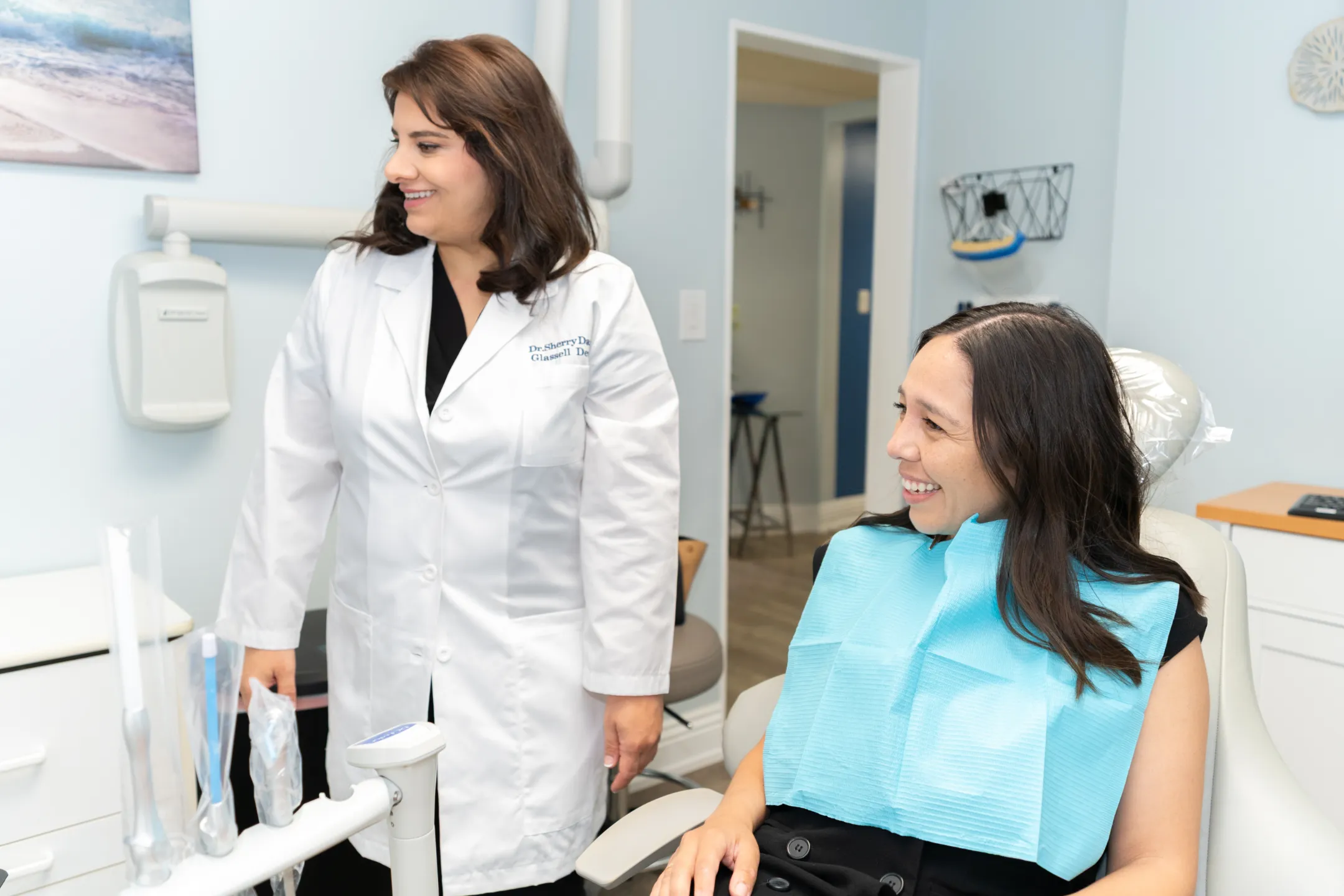 Smiling patient chatting with their dentist at Glassell Dental