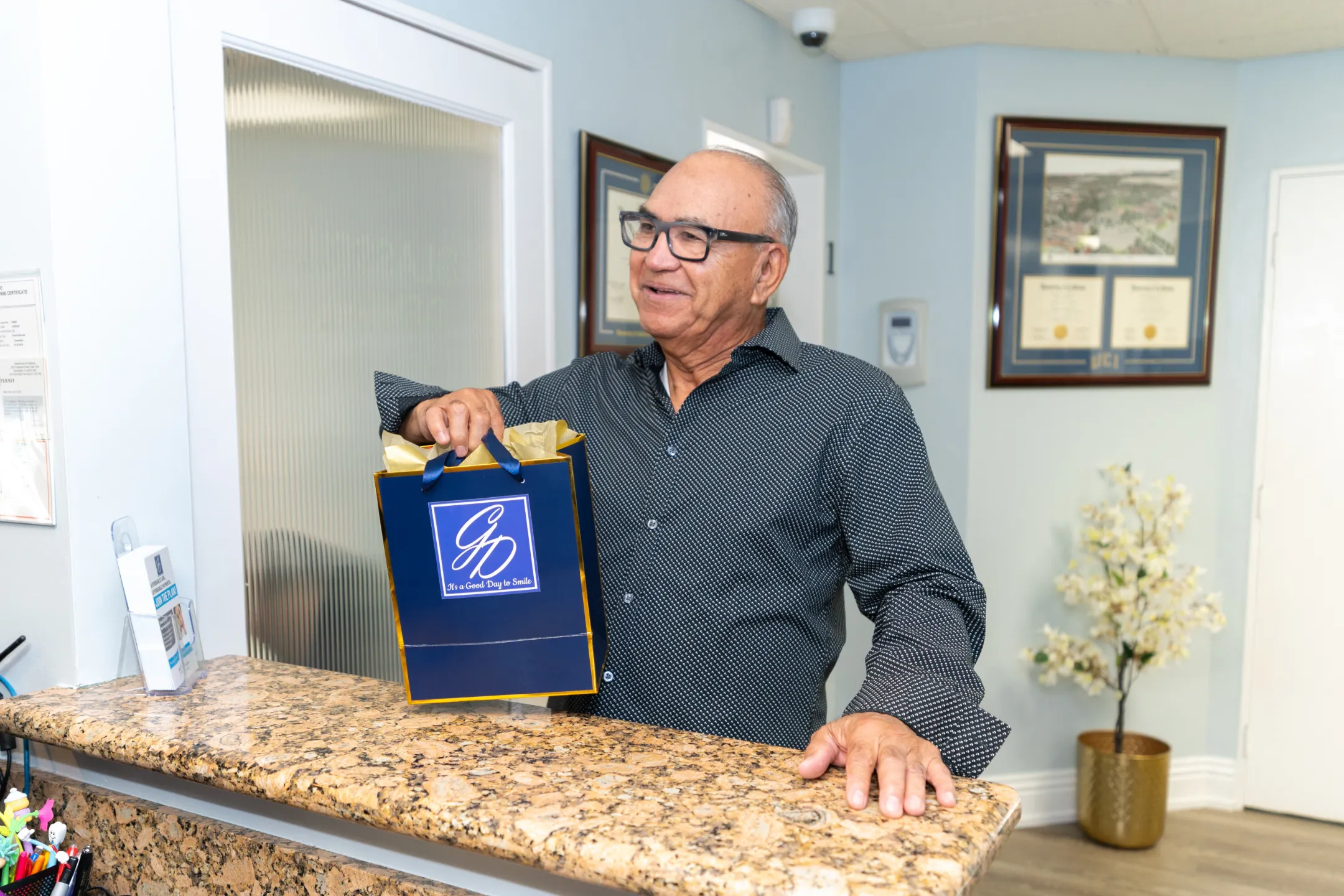 Happy Glassell Dental patient at the front desk after their visit